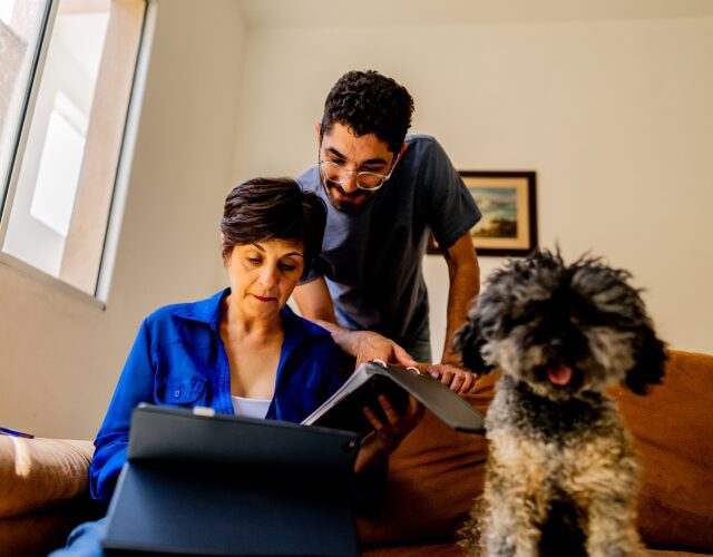 Couple reviewing documents with a dog nearby